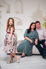 Obraz premium Family posing together with a girl in a dress celebrating a special moment