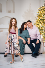 Naklejka premium Family together at a holiday gathering with a girl in a dress