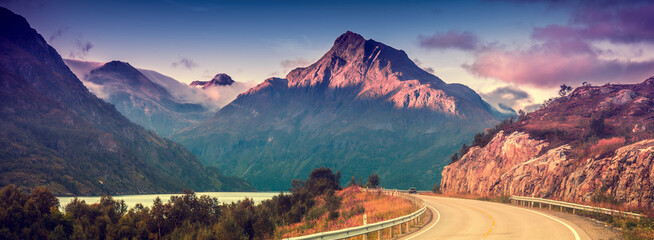 Fototapeta premium Driving a car on mountain road. Nature Norway. Polar circle. Lofoten islands