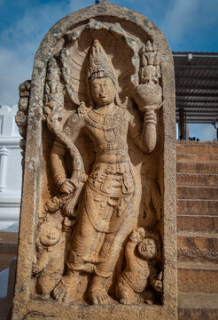 Ancient Stone Guardian Relief, Anuradhapura Sri Lanka, Carved Temple Sculpture with Deity Figure and Attendants, Archaeological Heritage Monument, Traditional Sri Lankan Stone Art, stone sculpture