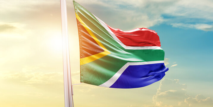 South Africa national flag waves on soft sky.