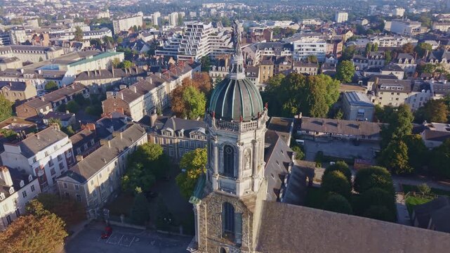Historic Notre Dame en Saint Melaine church and the cityscape of Rennes in Brittany, France. Aerial orbiting