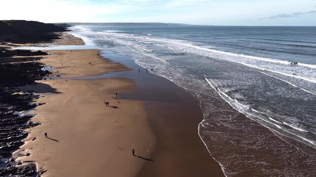 Dog walkers and surfing beach Sandymouth Bay Cornwall