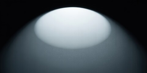 A bright white sphere glowing in the dark space with a spotlight effect