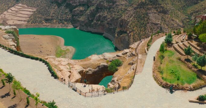 Aerial view of Delikli Tas (Rasıl Hacar) and the turquoise river in Botan Valley, Sirnak, Turkey. Unique canyon landscape and natural rock formations in Eastern Anatolia.