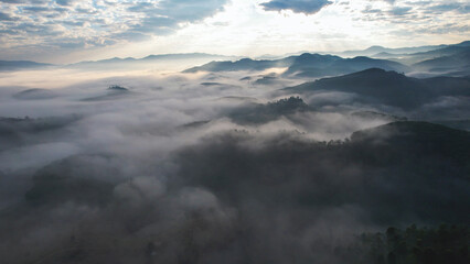 Obraz premium Aerial view of mountains and forest with the sea of fog by drone
