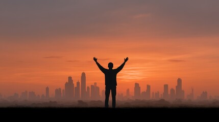 Silhouette of a Person with Outstretched Arms Against a Vibrant City Skyline During Sunset on a Foggy Evening