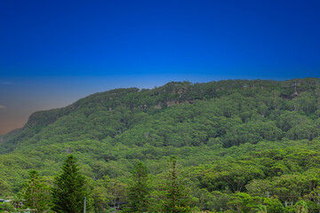 Fototapeta premium Sea Cliff Bridge on the southern coast of Sydney with sweeping Ocean Views and Mountain terrain. a major Bridge Road on the beautiful Australian coastline Australia