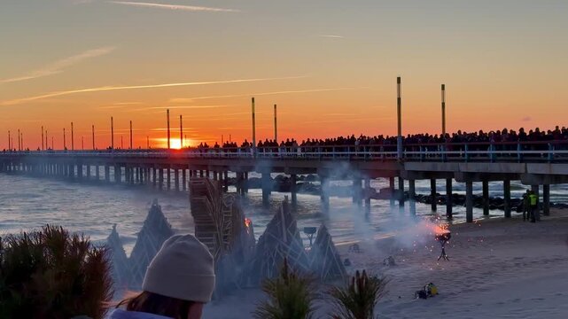 Jurgines (St. George's Day) Celebrating in Palanga. Burning a dragon figure on the Baltic Sea coast. Fire engulfs a large dragon-shaped structure made of wood on the sandy beach of Palanga, Lithuania