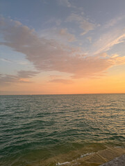 Obraz premium Water surface at sunset with warm light and reflections