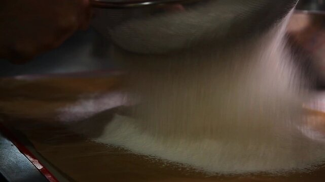 Flour being sifted and prepared for baking