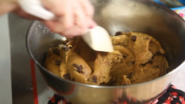Ingredients of chocolate chips cookies being mixed