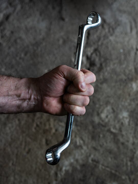 The mechanic throws the wrench out of his hand and it goes into free fall.