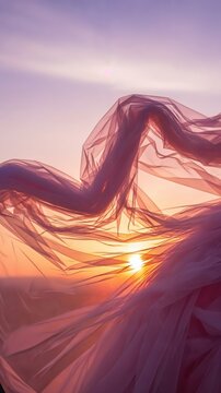 Flowing pink tulle fabric blowing in the wind at sunset, ethereal romantic background for wedding concept