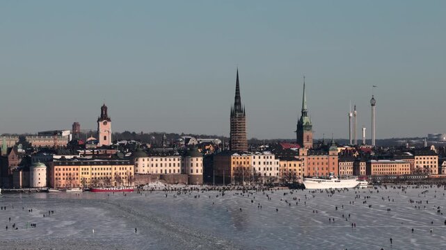Stockholm, Sweden People ice-skating in front of Gamla Stan on a cold, sunny winter day. 