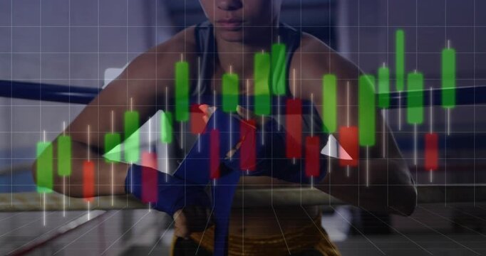 Female boxer grabbing blue wrap pre-training, wrapping wrist while transparent finance chart shifts