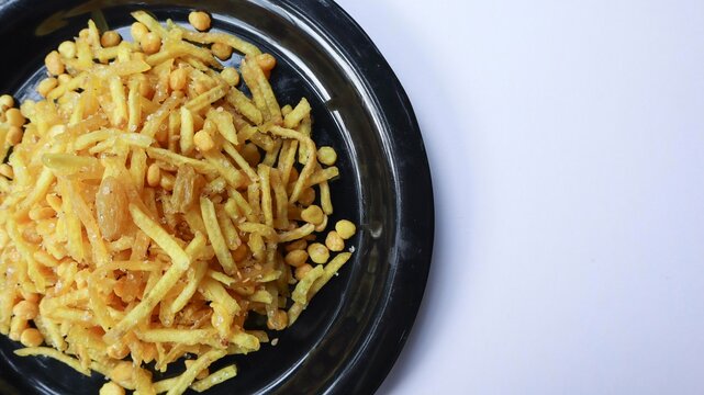 Vrat ka khana, Upawas snacks Farali chevdo, or faradi sev made of deep fried potato, raisins and sago pearls on white background
