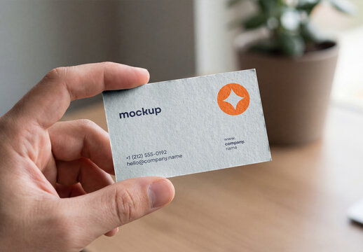 Hand Holding Business Card Mockup In Minimalist Office Setting, Real Person Presentation Stationery Template
