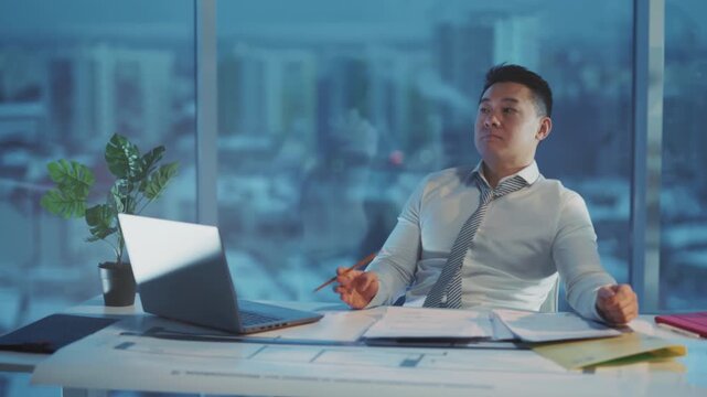 Manager reviews plans indoors calmly, Business leader pauses reflecting during intensive planning moments