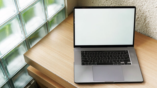 Modern Space Gray MacBook Pro Mockup on Minimalist Wooden Desk with Blank Screen