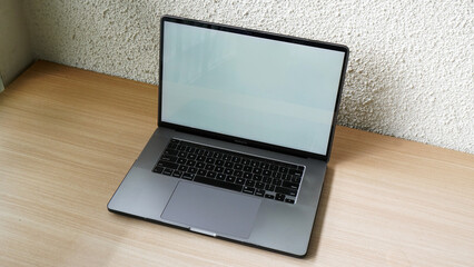 Modern Space Gray MacBook Pro Mockup on Minimalist Wooden Desk with Blank Screen
