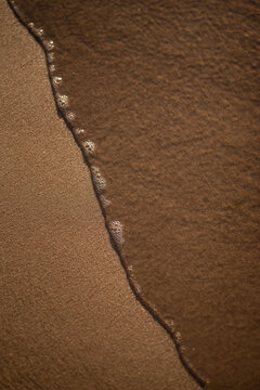 sand and water, slow sea wave on the sand