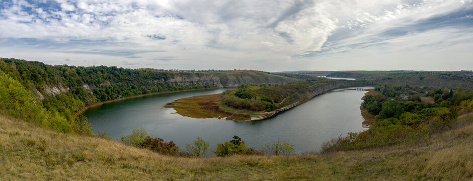 Bends Zbruch river in canyon-like valley with rock banks