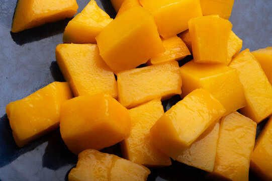 Ripe and tasty vibrant orange egyption Mango cubes. macro shot