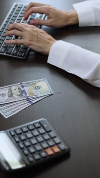 Close up view of woman hands and American dollar (USD) banknotes. Concept of bank office work, saving money for retirement, cash settlement, financial success, literacy and income planning in USA.