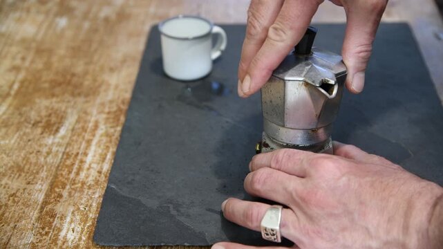 Making coffee with Moka pot. Italian espresso coffee in moka close-up.