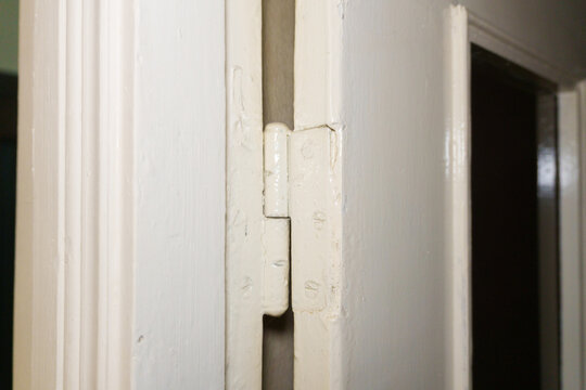 Old door hinges on a wooden door in an apartment, hinge repair. High quality