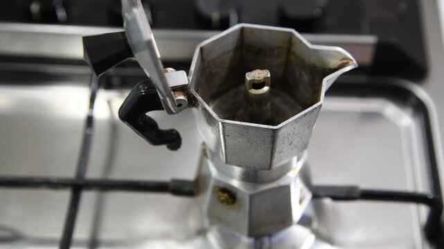 Making coffee with Moka pot. Italian espresso coffee in moka close-up.