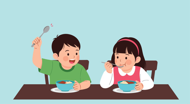 Young boy and girl sit at a table while enjoying a healthy meal from blue bowls with spoons against a soft blue background in a home kitchen.