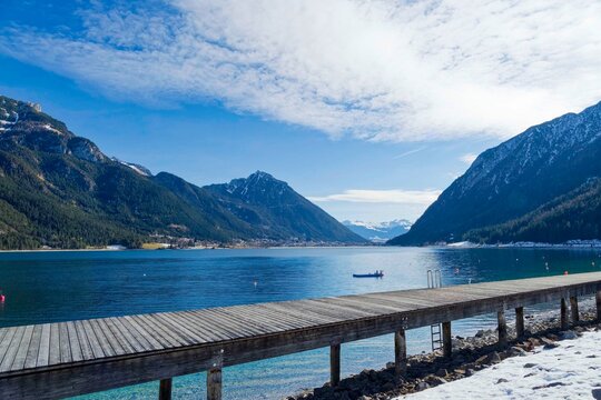 View from Pertisau nestled in the west shore of the idyllic turquoise-blue Lake Achen (Achensee) between the Karwendel and the Rofan Mountains in Austrian Tyrol