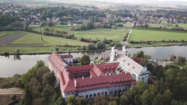 Slight drone curve forward around the Benedictine Abbey at river Vistula, Poland