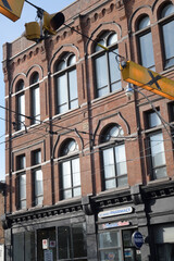 Fototapeta premium exterior building facade and sign of St. Mary Pharmacy located at 796 Queen St E, Toronto (known as Poulton Block, once Orient Hall Masonic Lodge, 1886)