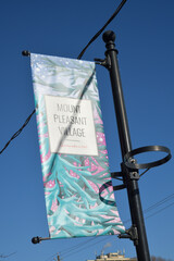 Fototapeta premium Mount Pleasant Village banner isolated on a blue sky, Toronto