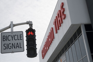 Fototapeta premium defocused Bicycle Signal and sign outside Canadian Tire, a department store, located at 1025 Lake Shore Blvd E, Toronto