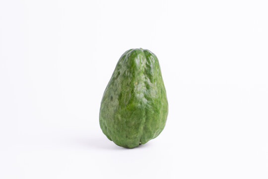 Fresh green chayote or sechium edule isolated on white background. Raw organic vegetable for healthy cooking ingredient.

