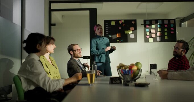 Business team meeting in office discussing project updates and ideas during morning hours with snacks and drinks on the table