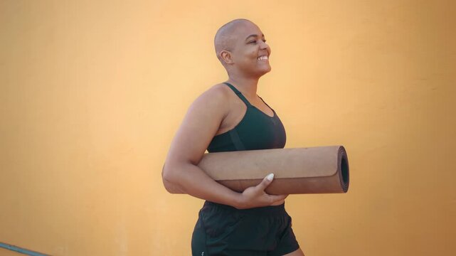 Muscular plus-size athlete standing confidently against concrete wall, embodying strength, determination, and body positivity with intense gaze 