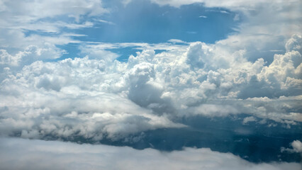 Cloudscape. Cloud cover under an airplane's wing while flying over a tropical zone during the monsoon season. Many towering cumulus clouds