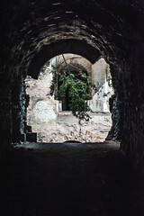 Obraz premium View Through a Dark Archway of an Abandoned Stone Ruin