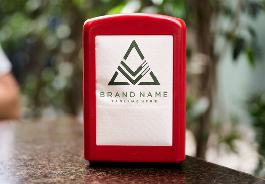 Real photo of red Napkin Holder on a Bar Table. PSD template mockup