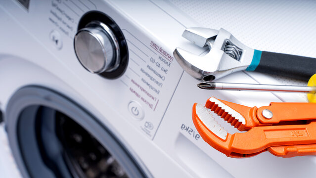 Washing machine repairman fixing the washing machine