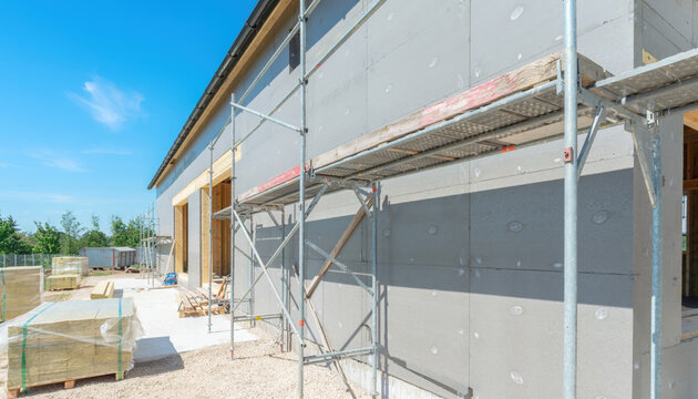 Building exterior wall with insulation and scaffolding