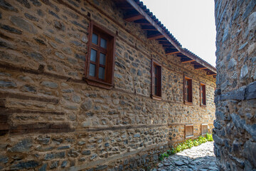 Obraz premium The colorful stone houses, wooden doors, and narrow streets of the historic Cumalikizik village located in Bursa Türkiye.