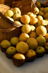 overflowing yellow apples in a basket