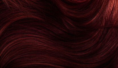 Dark red hair close-up as a background. Women's long brown hair. Beautifully styled wavy shiny...