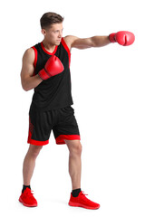 Athletic man in red boxing gloves fighting on white background